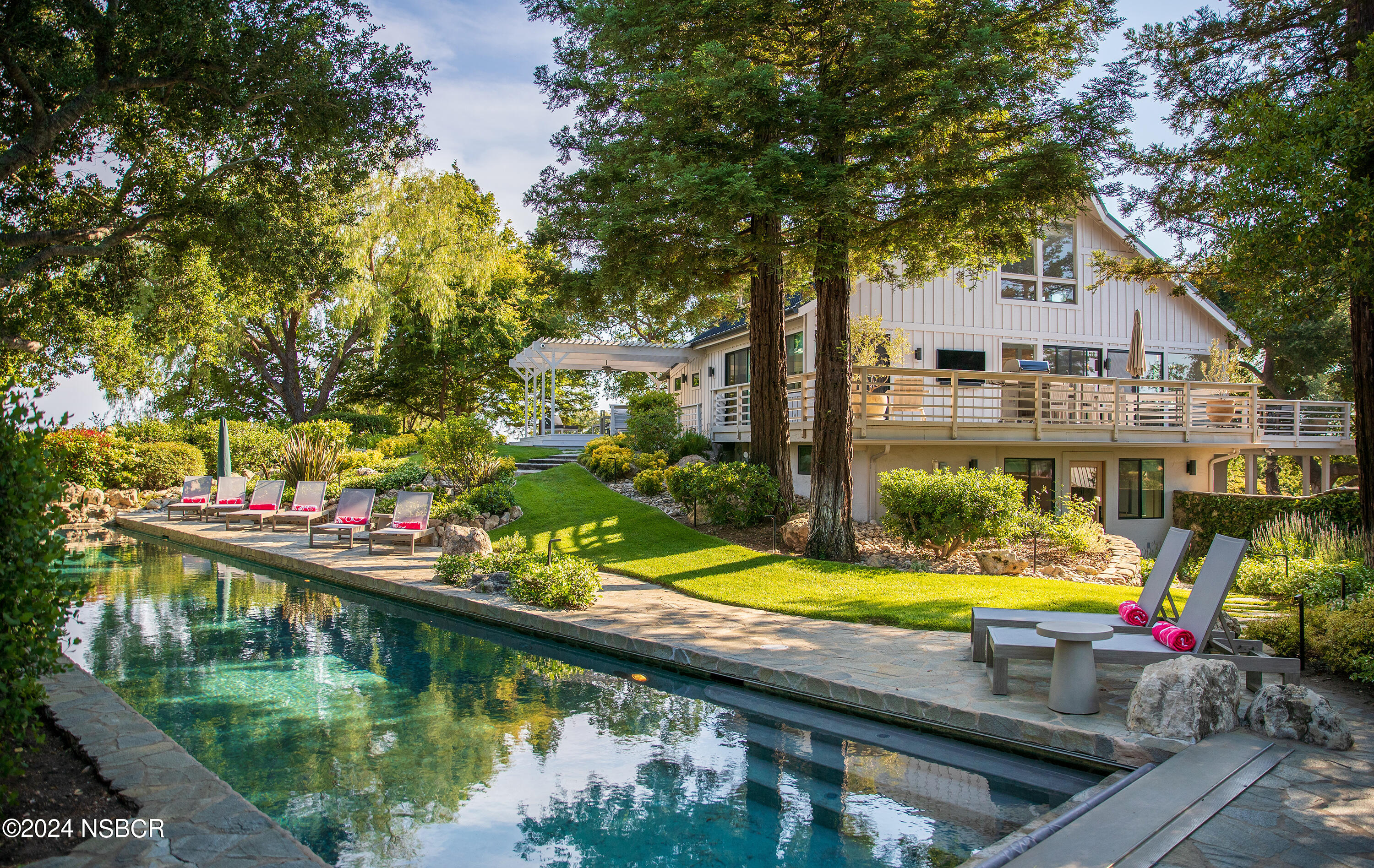 a view of swimming pool with a lounge chairs