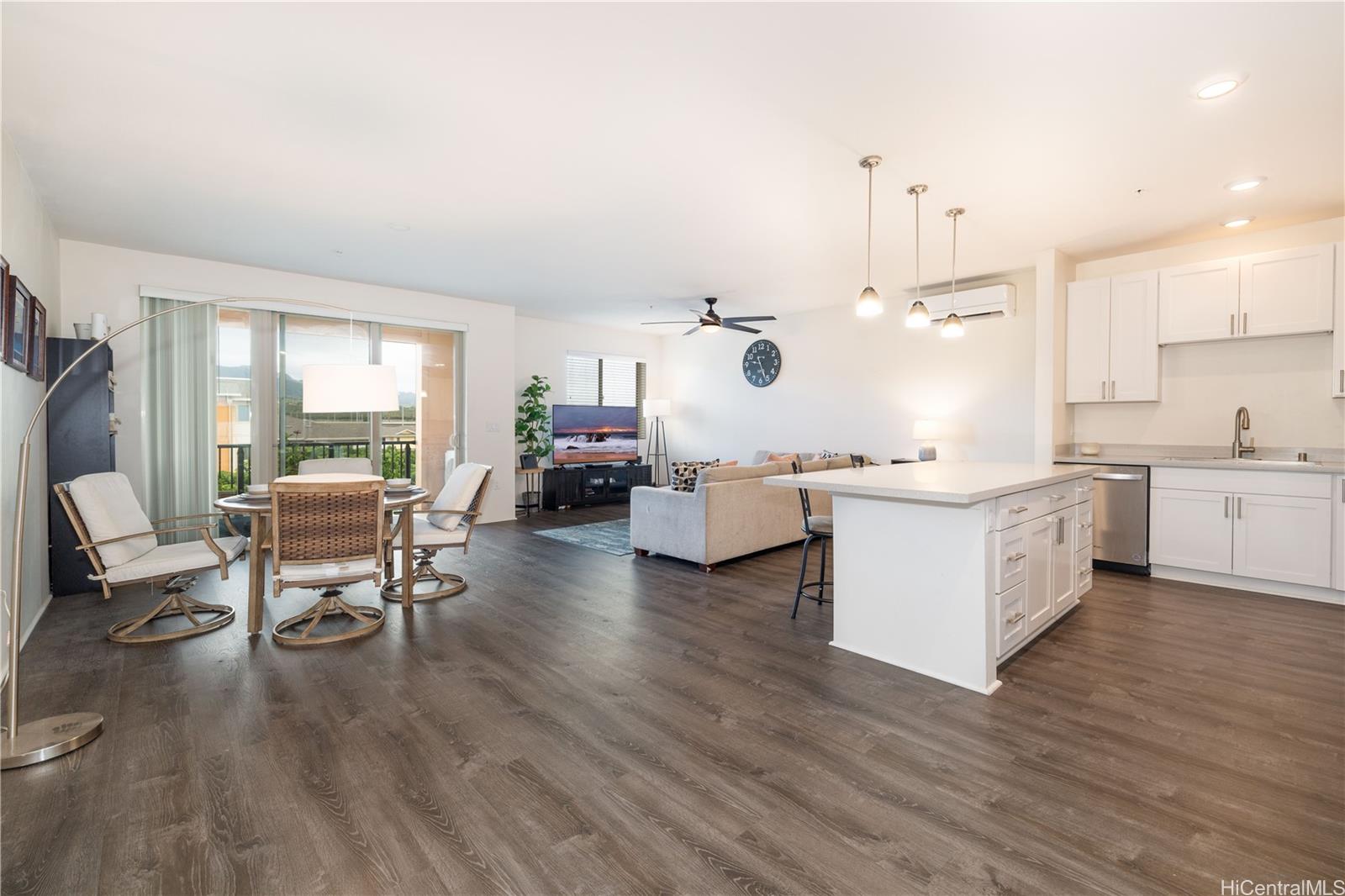 a living room with furniture and kitchen view