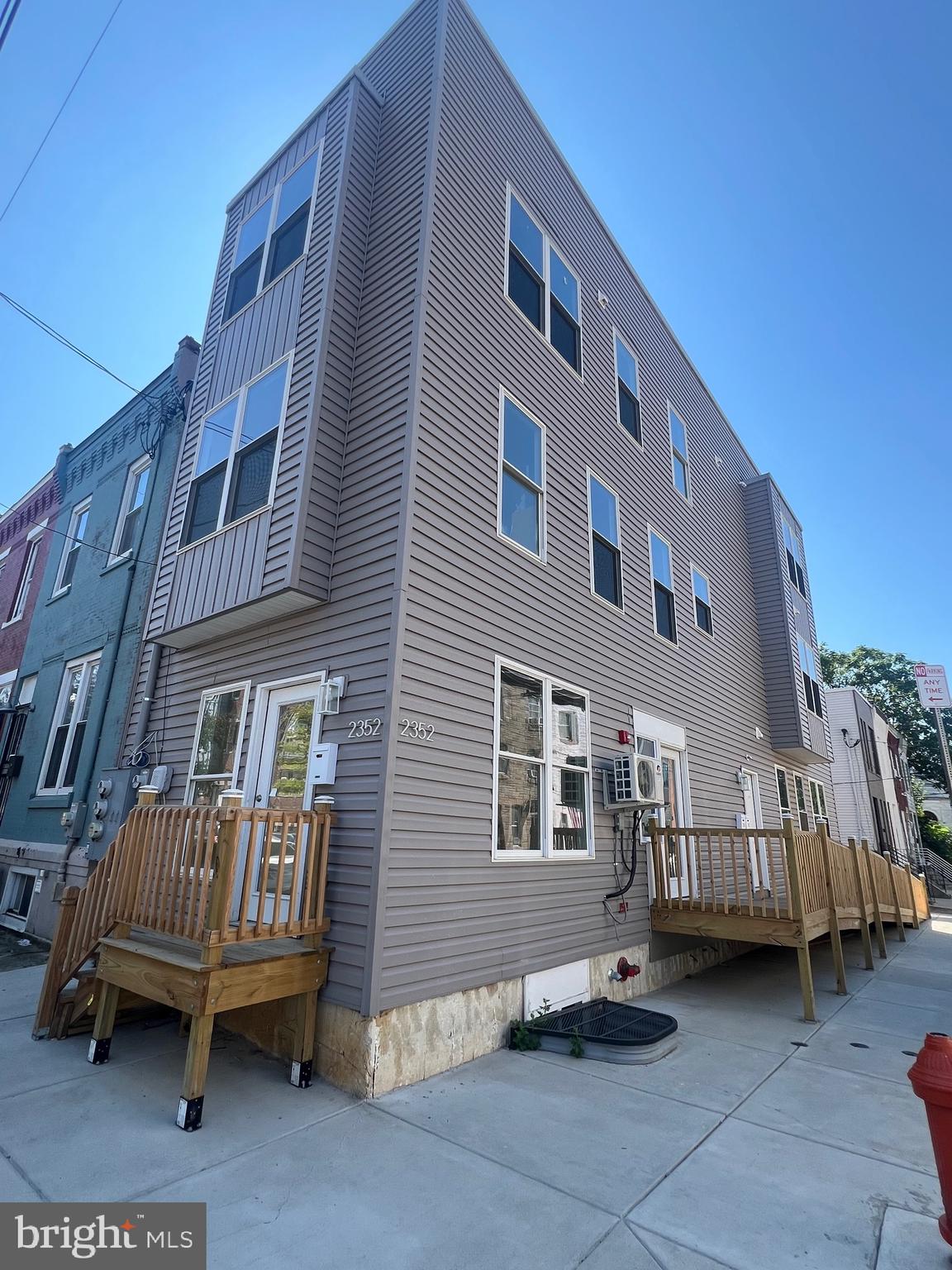 a view of a house with a backyard and deck