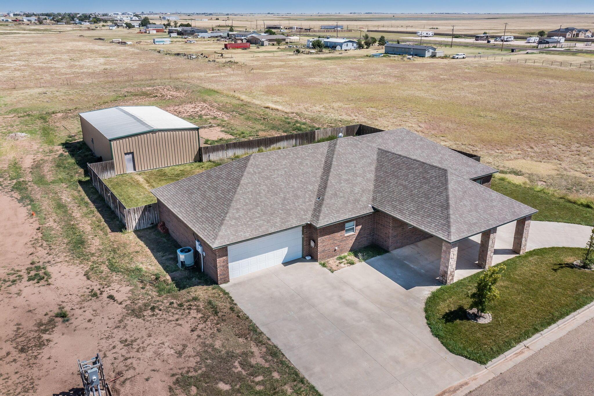 an aerial view of a house with a lake view