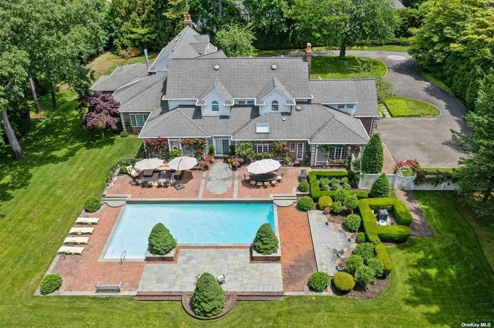 an aerial view of a house with garden space and street view