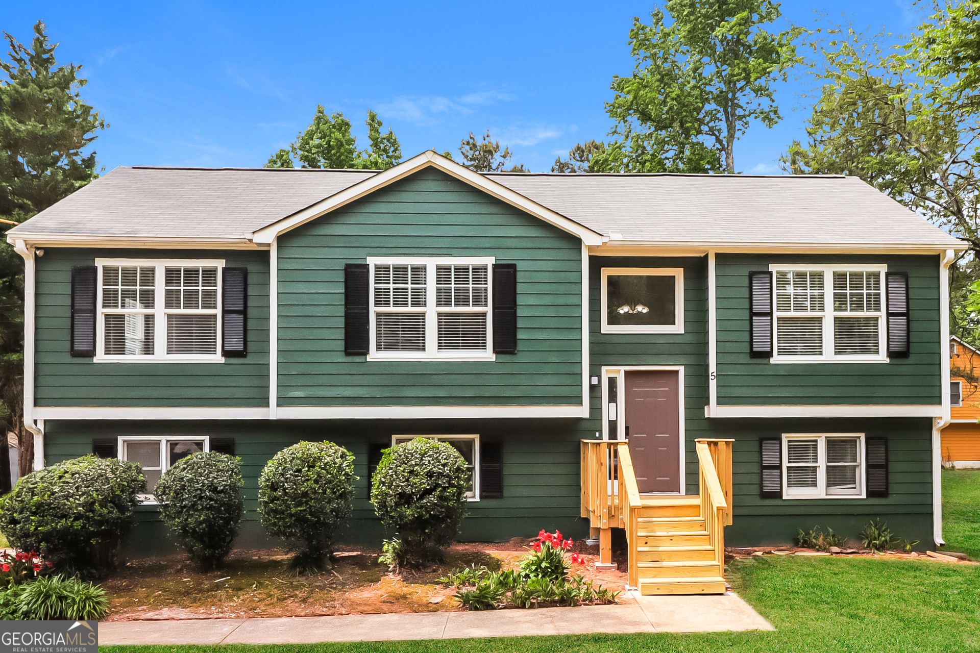 a front view of a house with a yard