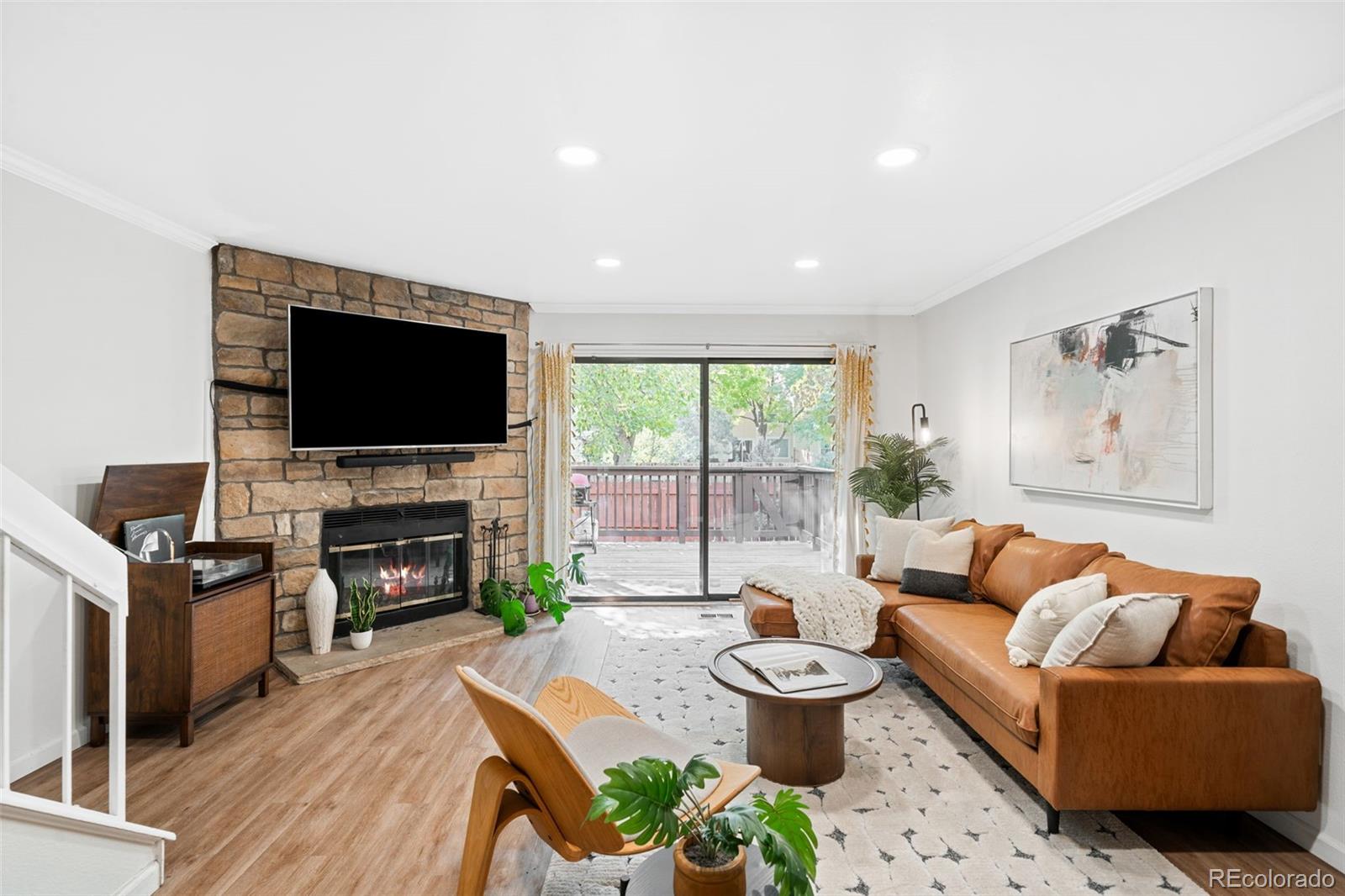 a living room with furniture a fireplace and a flat screen tv