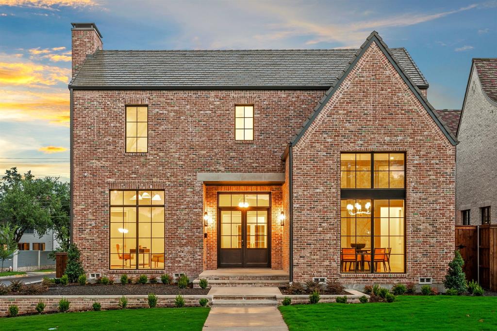 a view of a brick house with many windows