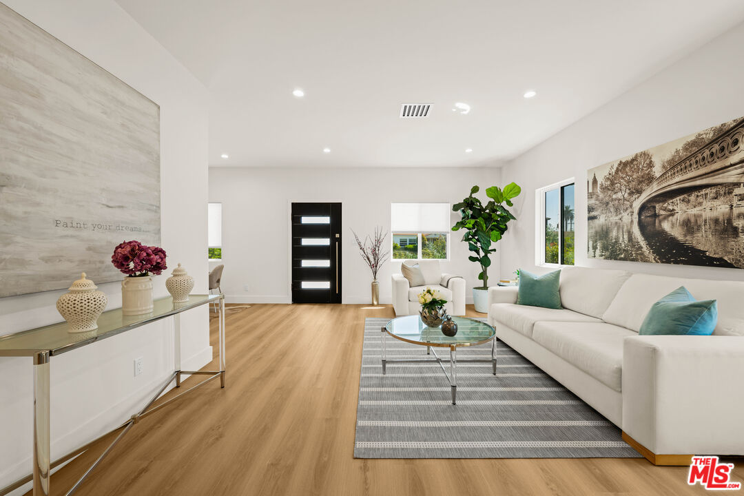 a living room with furniture and a potted plant