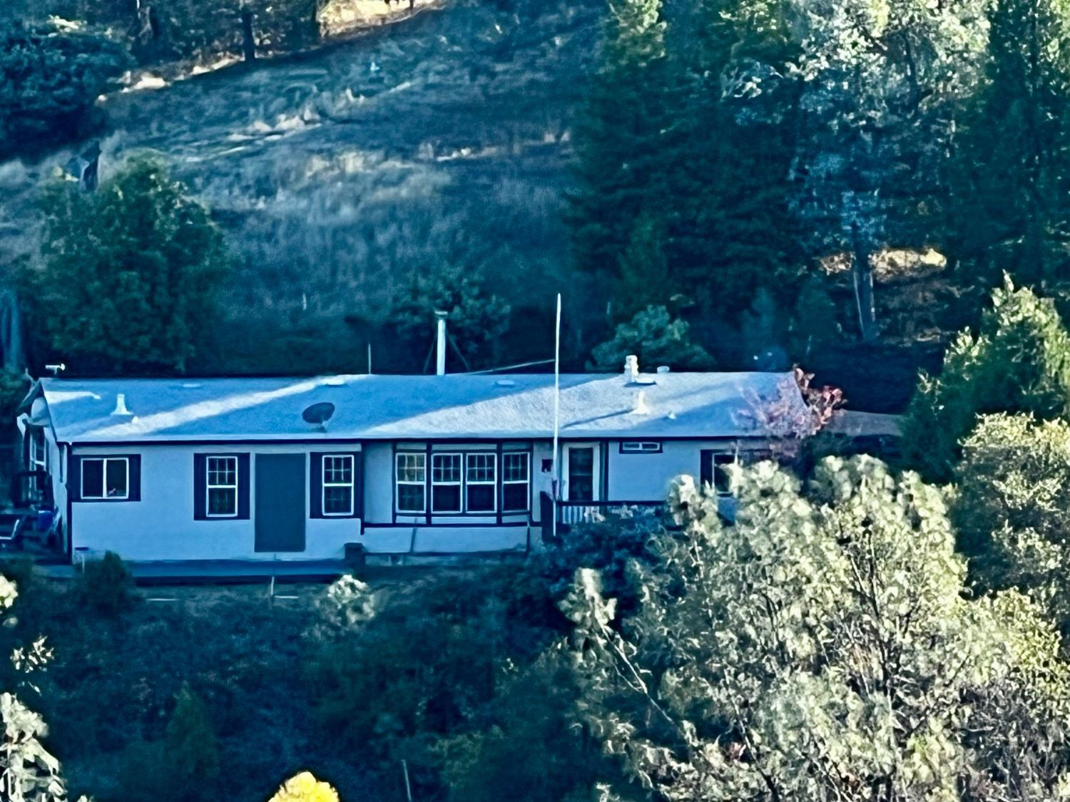 a view of a house with a yard and sitting area