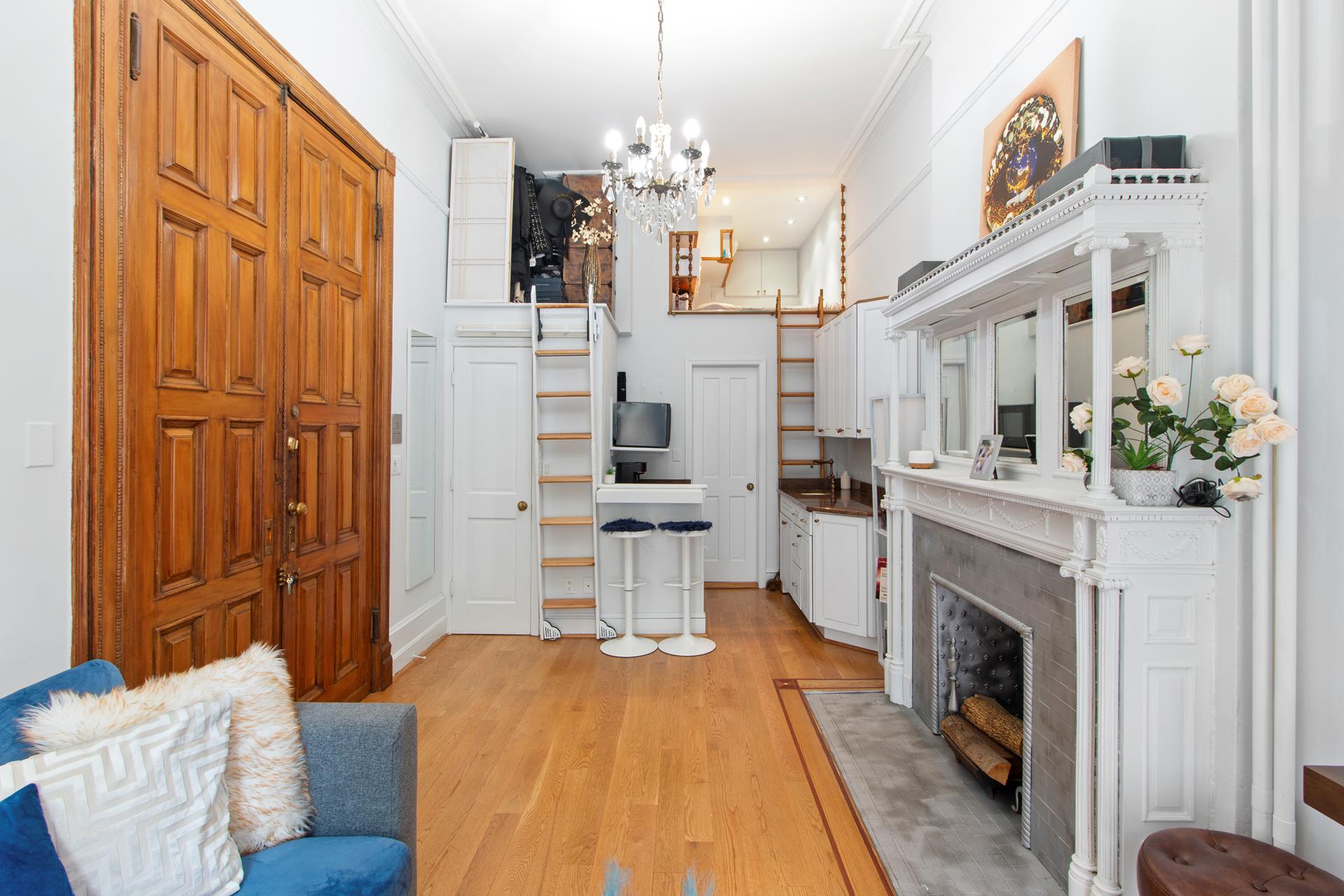 a living room with furniture a fireplace and a chandelier