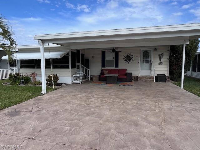 View of front of house featuring a front yard and a carport