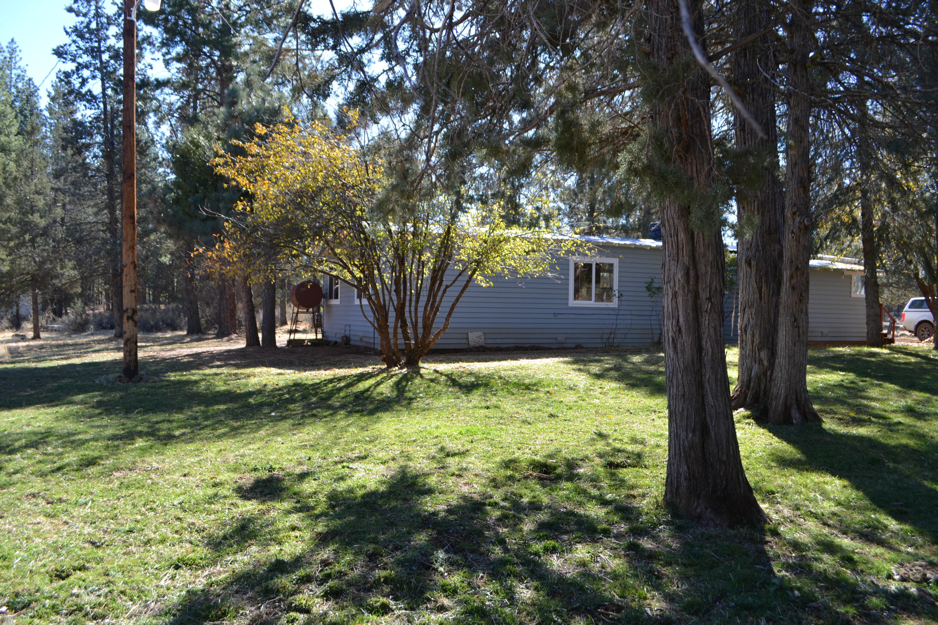 a view of backyard of house with green space