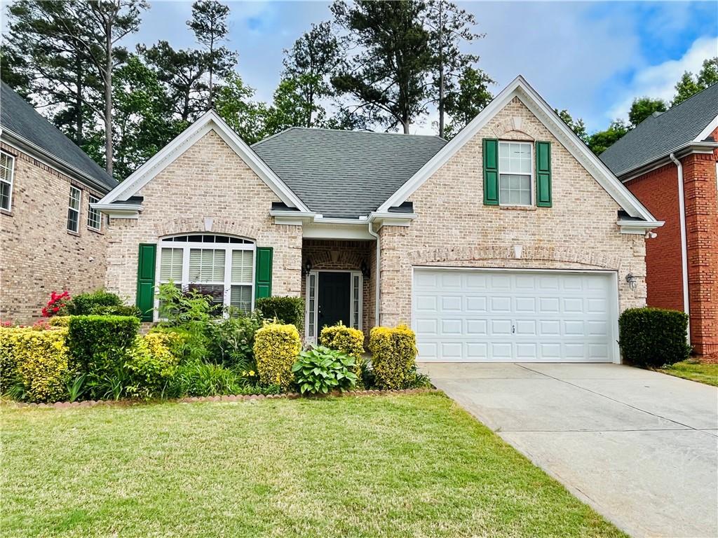 a front view of a house with a yard and garage