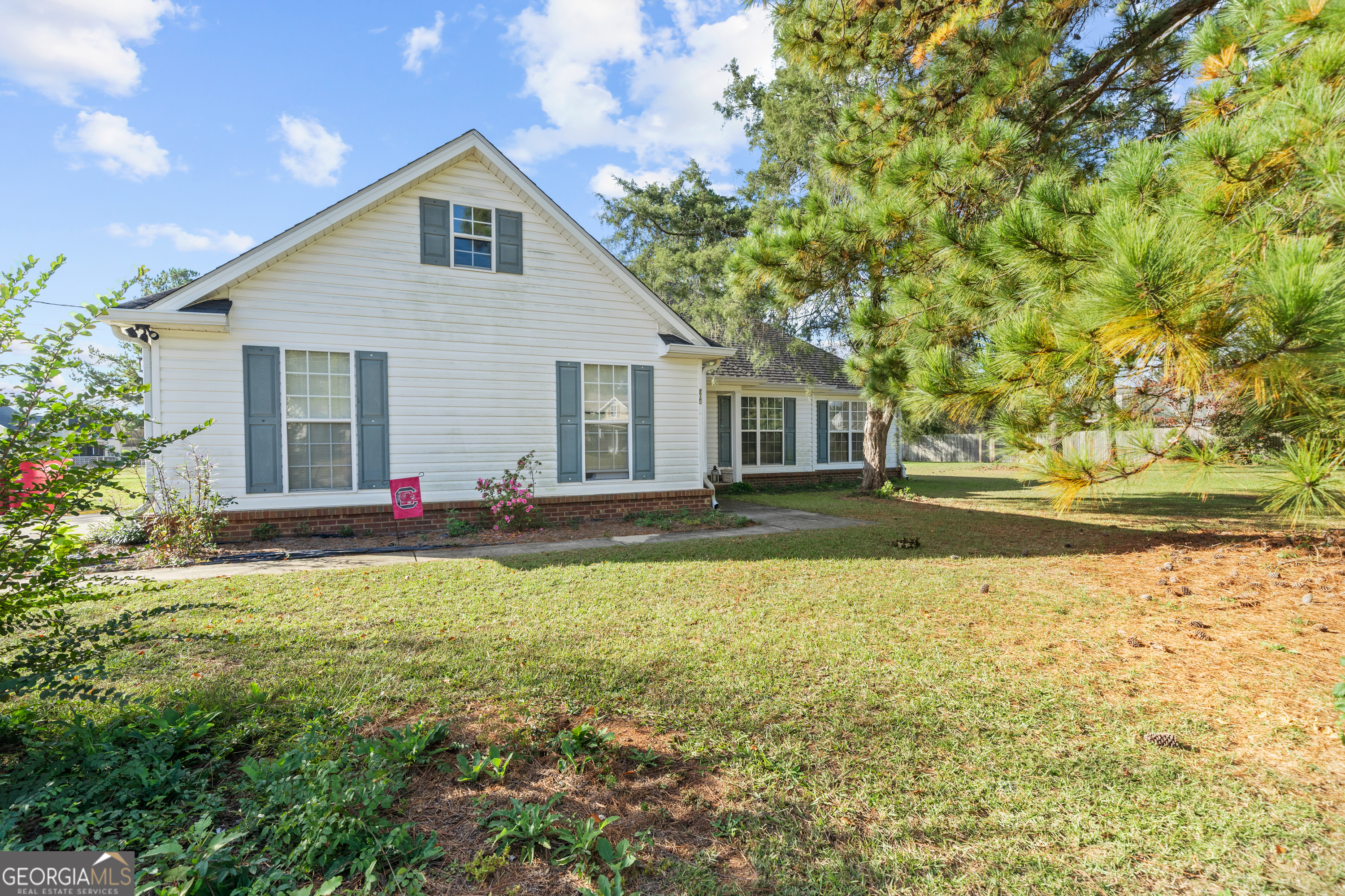 a view of a house with backyard and sitting area