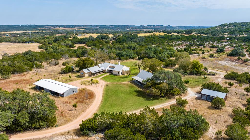 an aerial view of residential houses with outdoor space and river