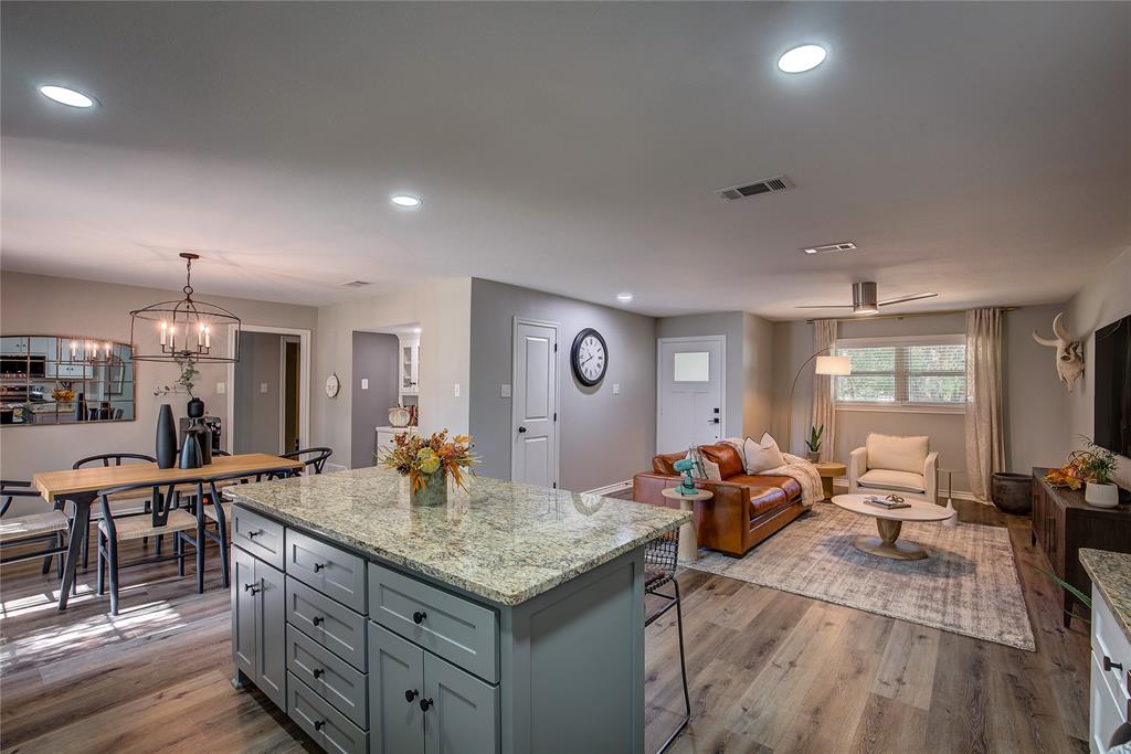 a living room with granite countertop kitchen furniture and a table