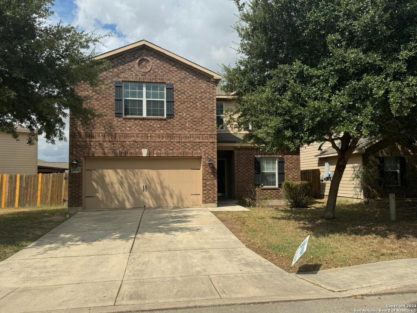 a front view of a house with garage