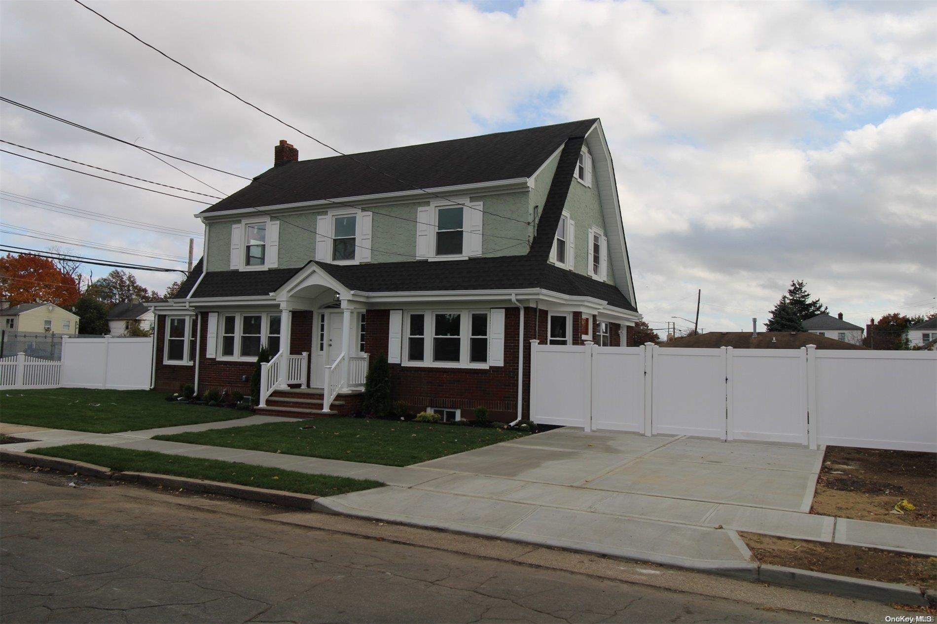 a view of a white house with a yard