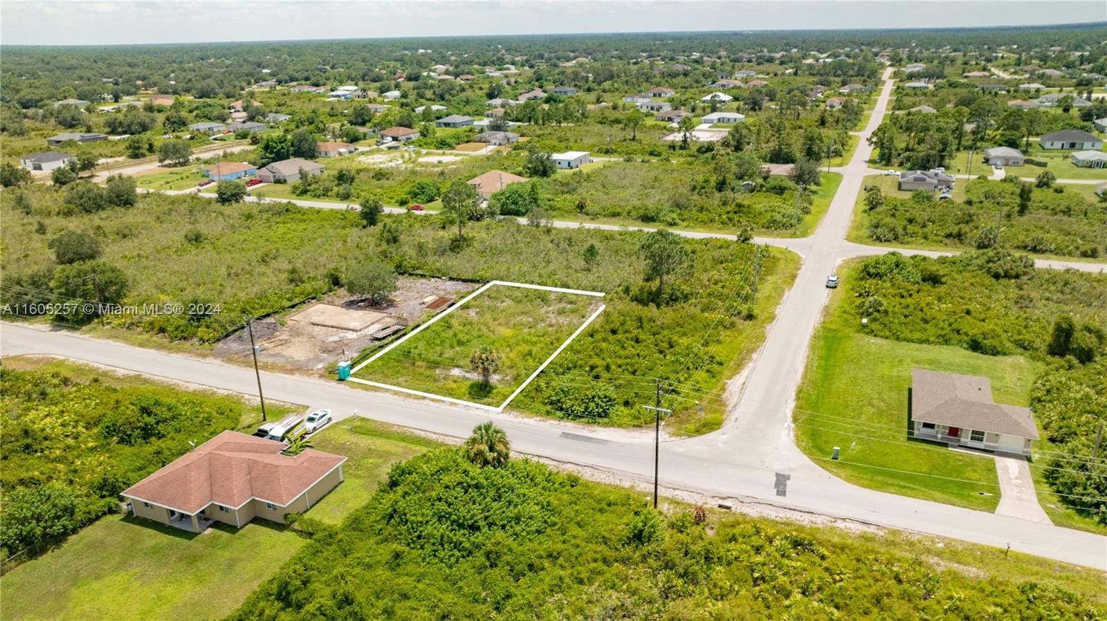 an aerial view of residential houses with outdoor space and street view