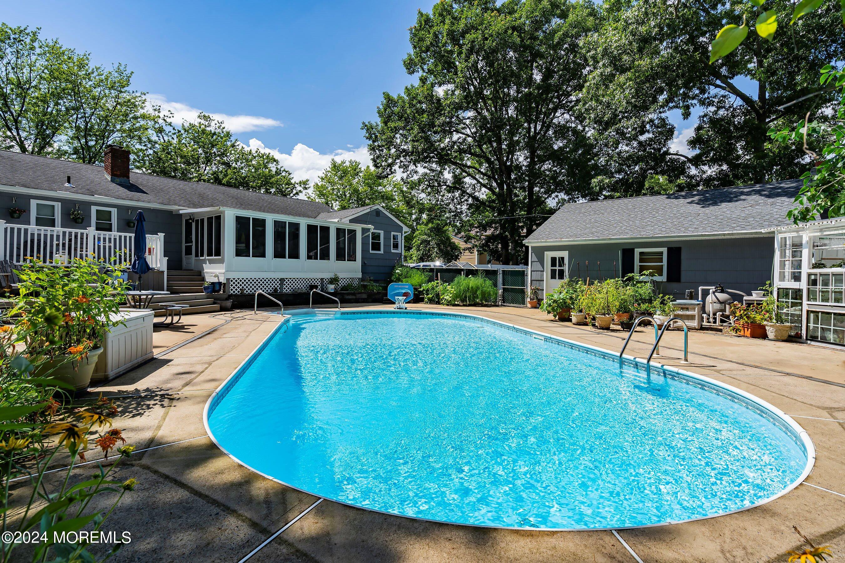 a view of a house with swimming pool and porch