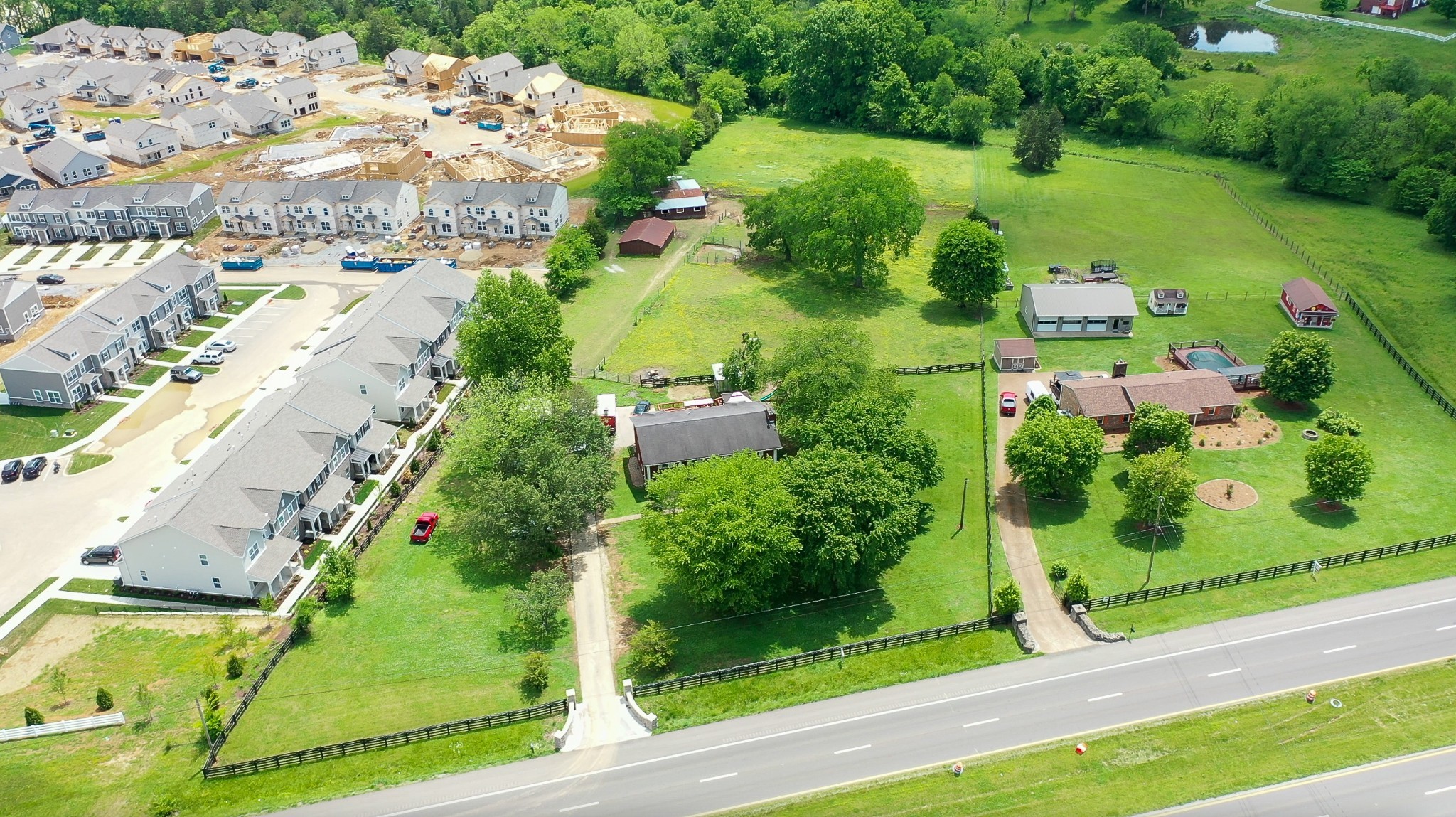 an aerial view of a residential houses with yard