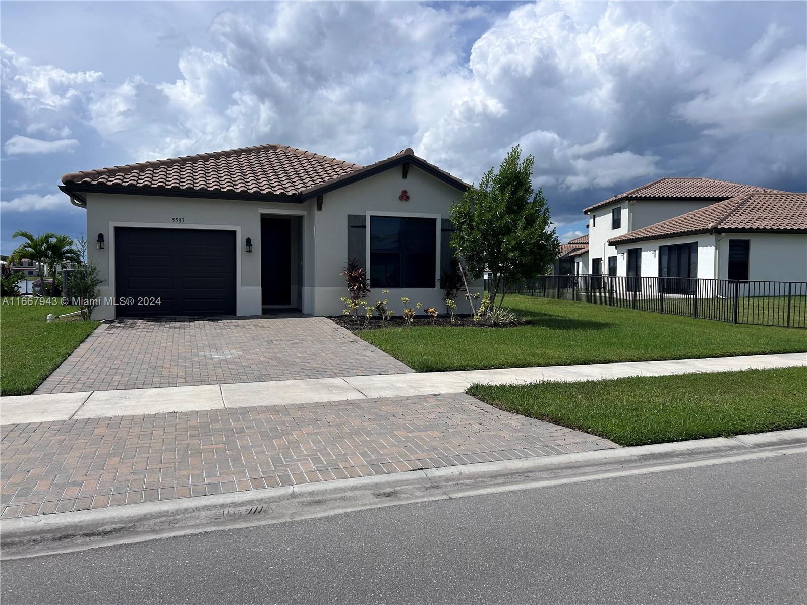 a front view of house with yard and green space