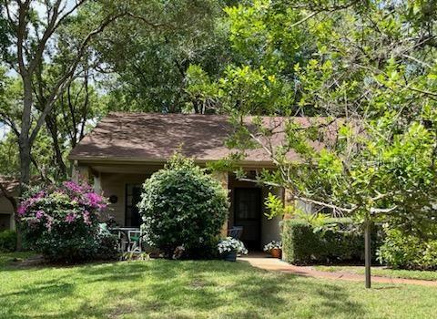 a view of a house with a tree and a yard