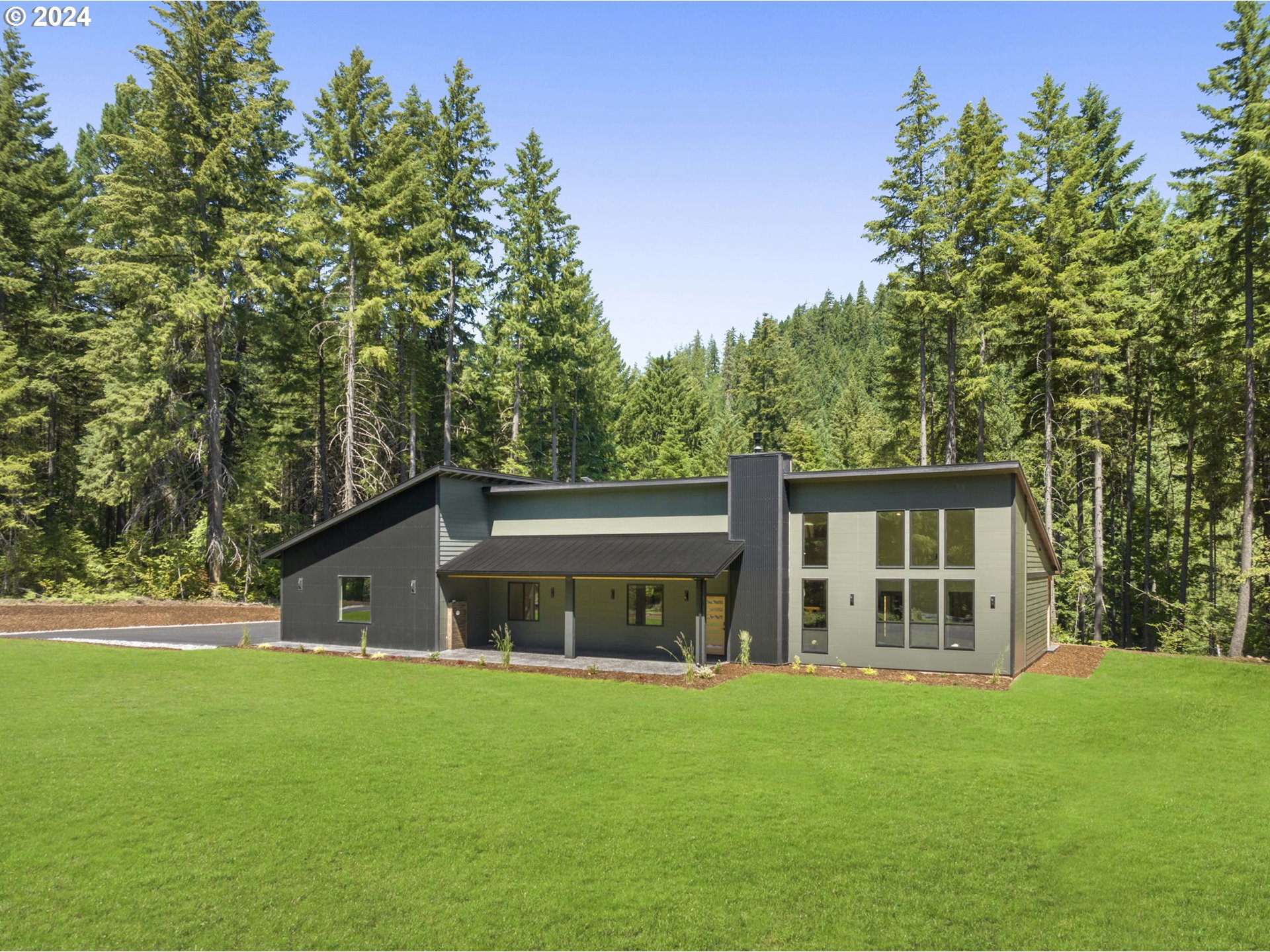 a front view of house with yard and green space