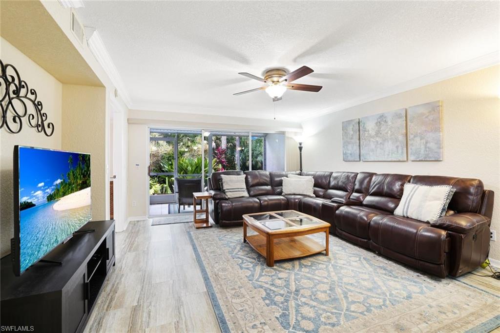 a living room with furniture a rug and a flat screen tv