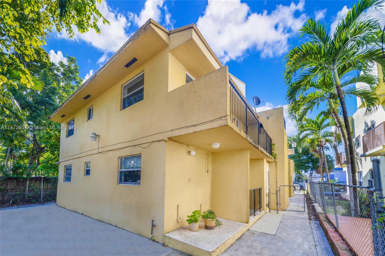 a view of a house with a palm tree