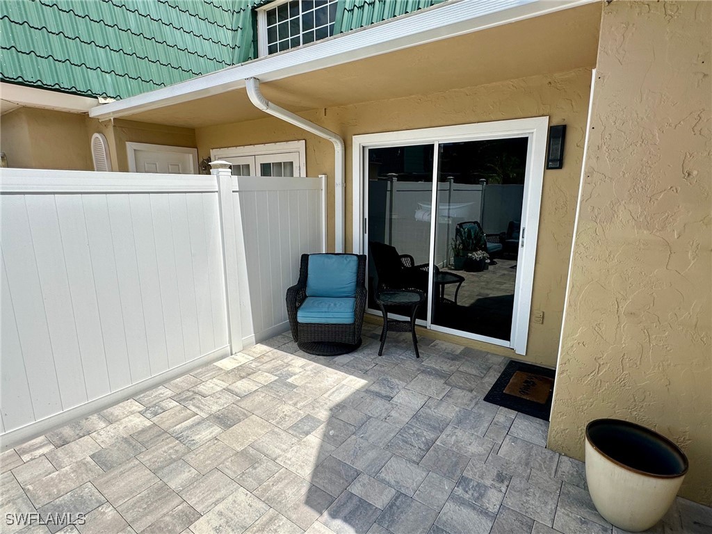 a view of patio with table and chairs