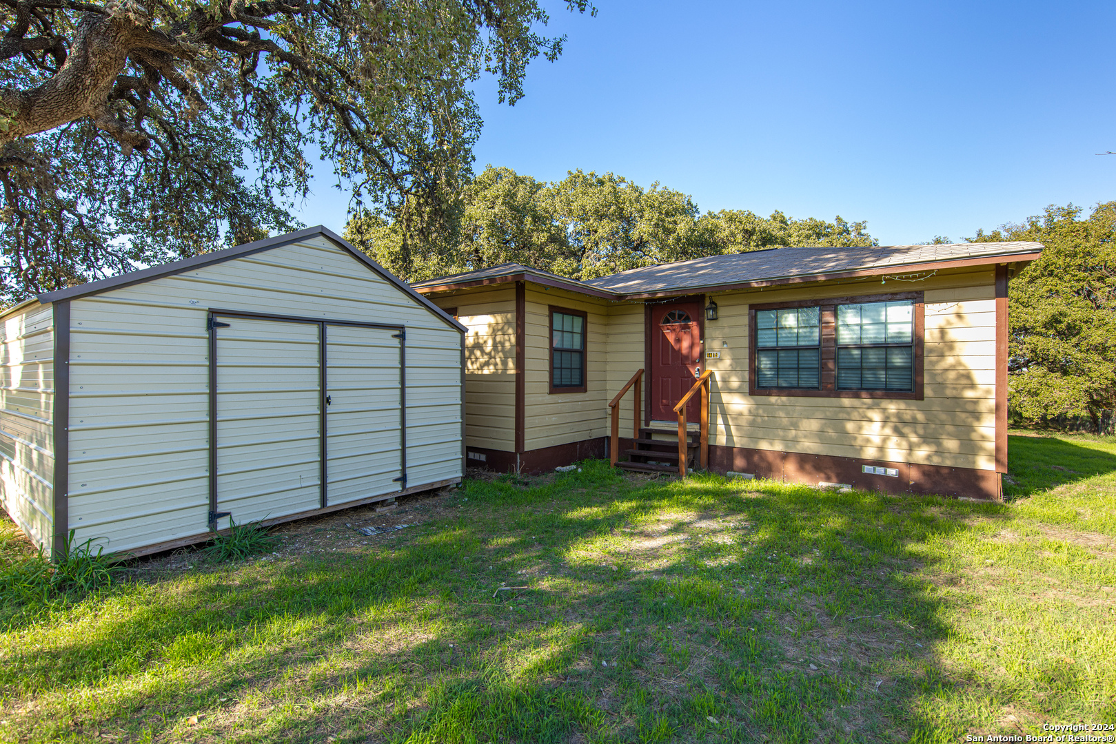 a view of a house with a yard and sitting area