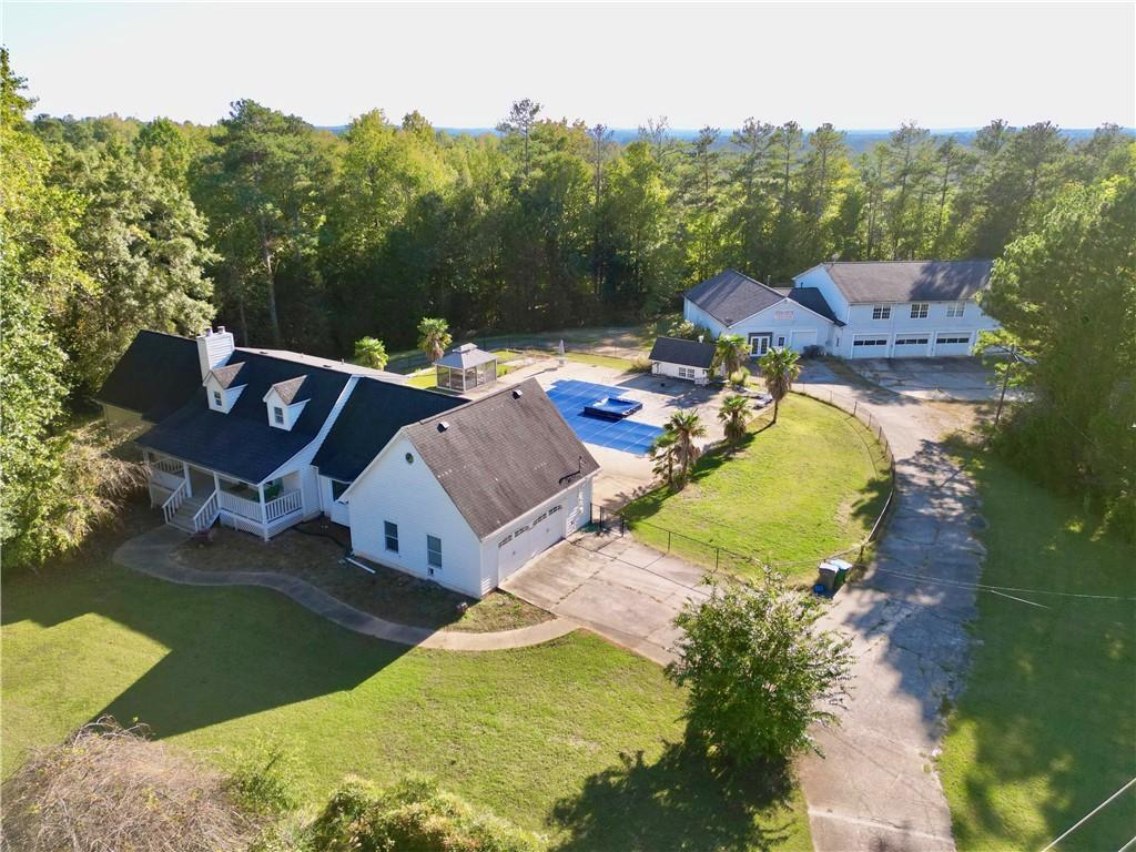 an aerial view of a house with swimming pool and 