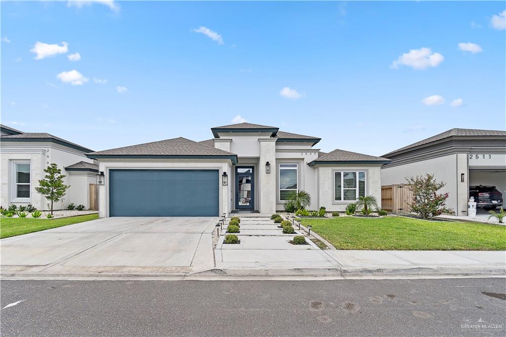 Prairie-style home with a front yard and a garage