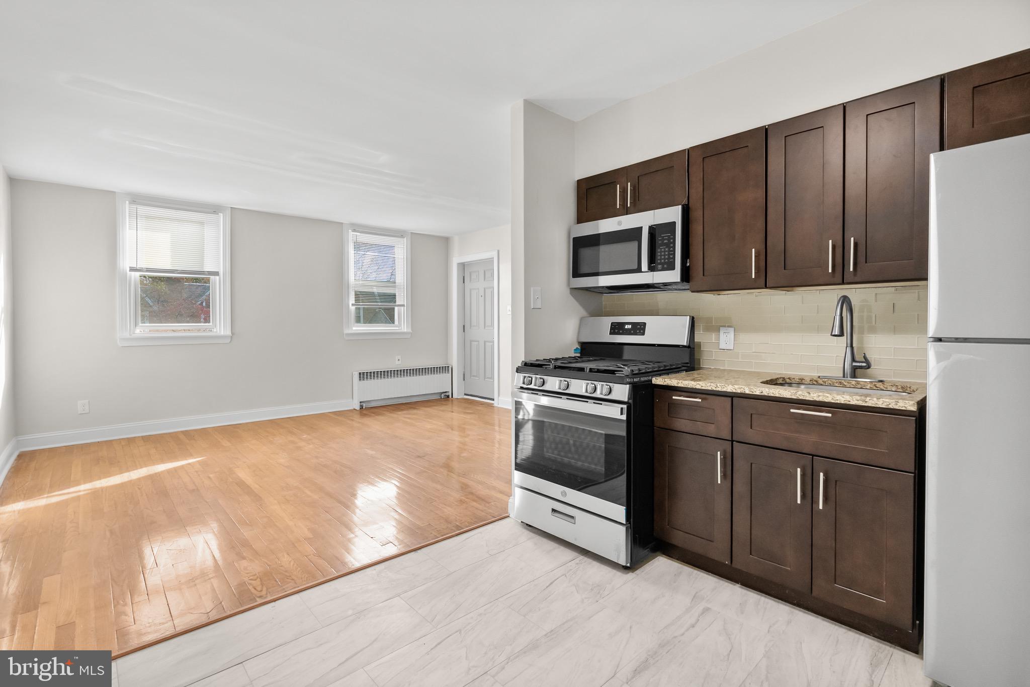 a kitchen with granite countertop a stove top oven and sink