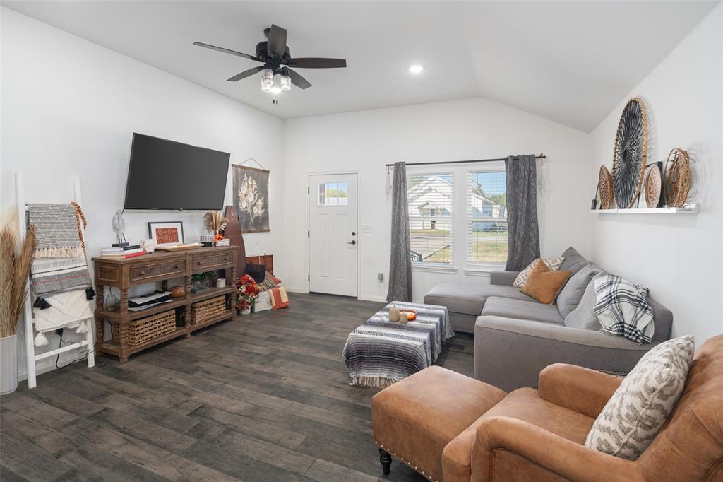 a living room with furniture and a flat screen tv