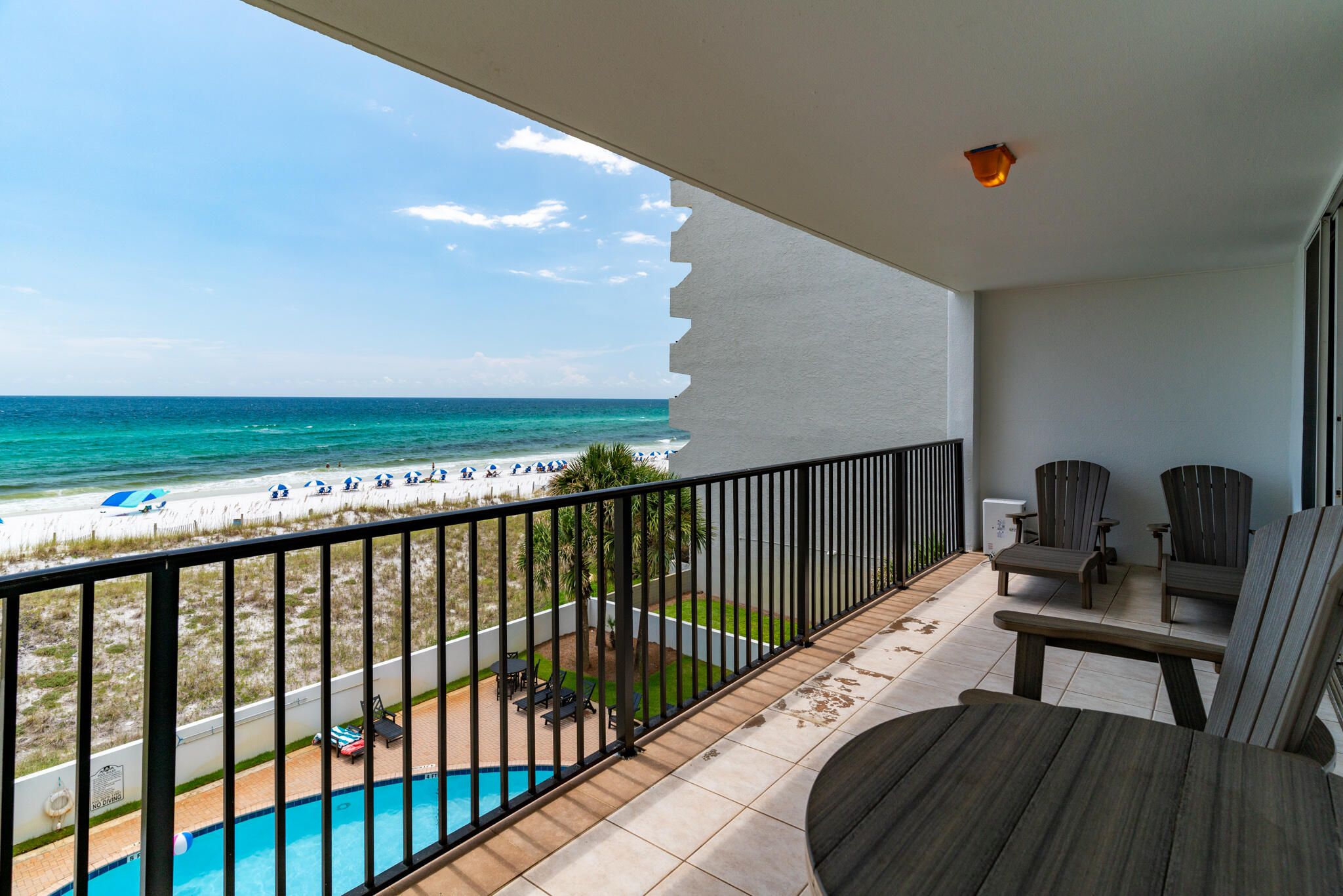 a balcony with table and chairs