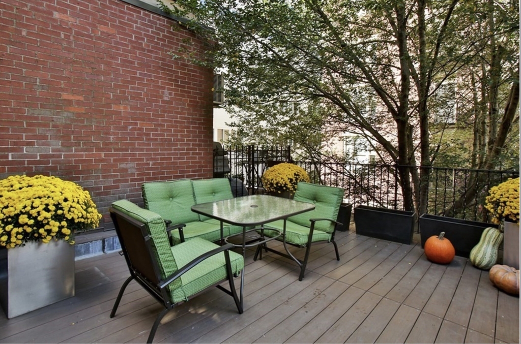 a backyard of a house with table and chairs