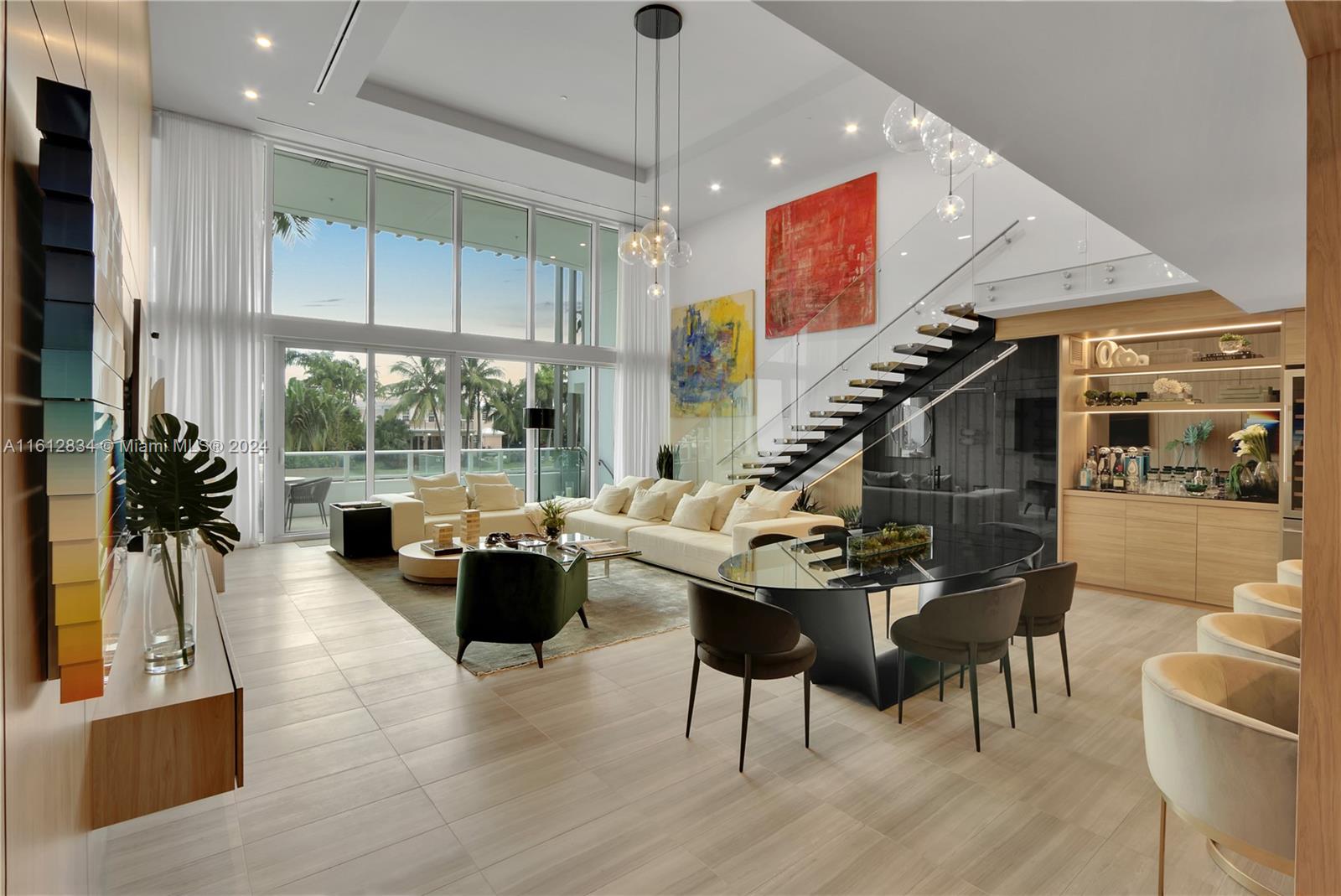 a living room with fireplace furniture and a large window