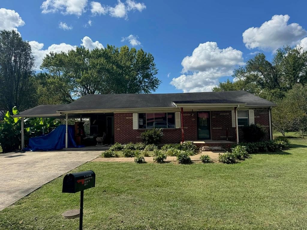 a front view of house with yard and outdoor seating