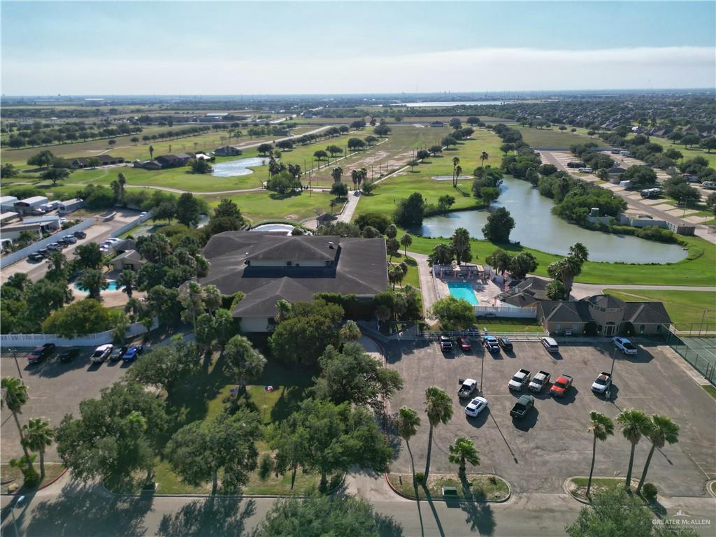 an aerial view of ocean and residential houses with outdoor space