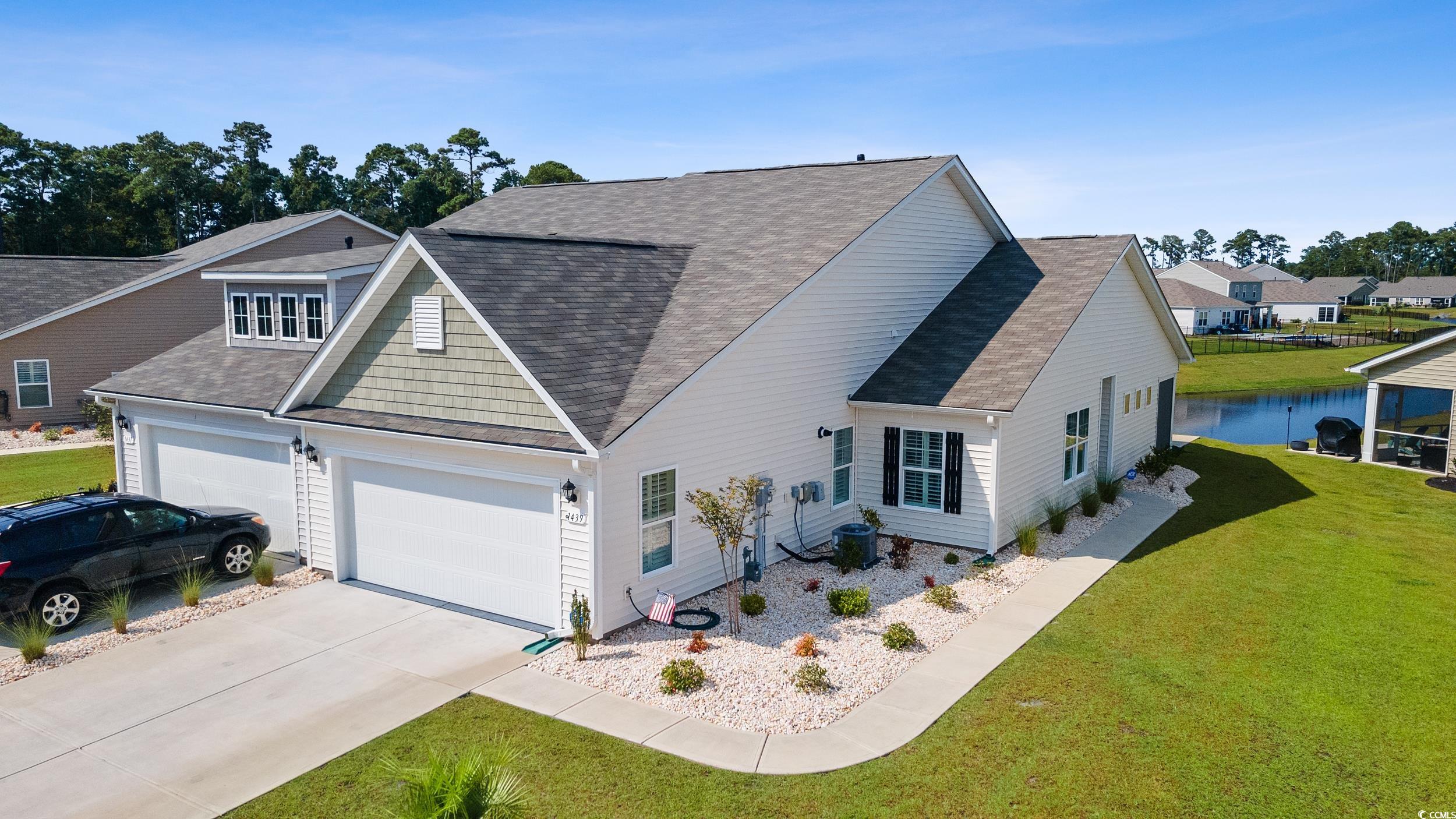 View of front facade with a garage and a front law