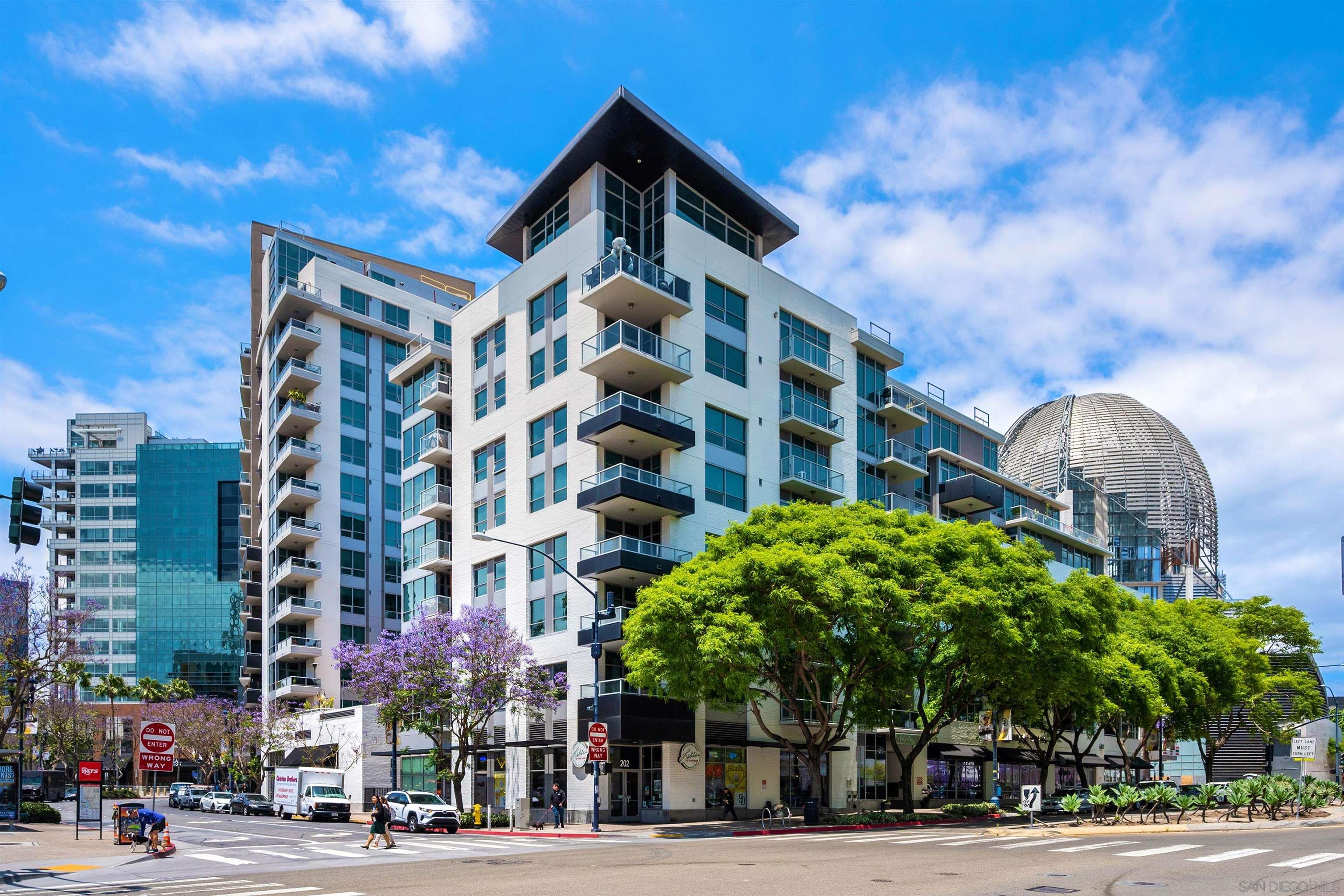 a view of a tall building next to a road