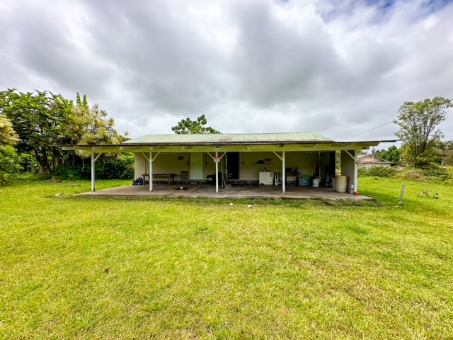 a view of house with an outdoor space and tub