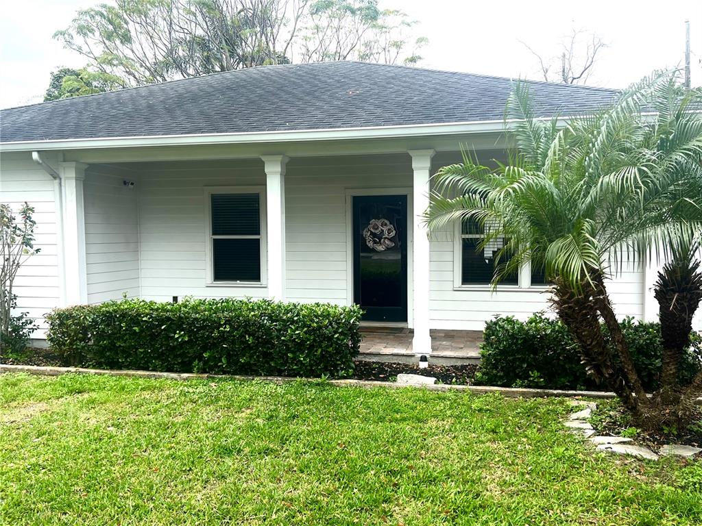 a view of a house with a yard and plants