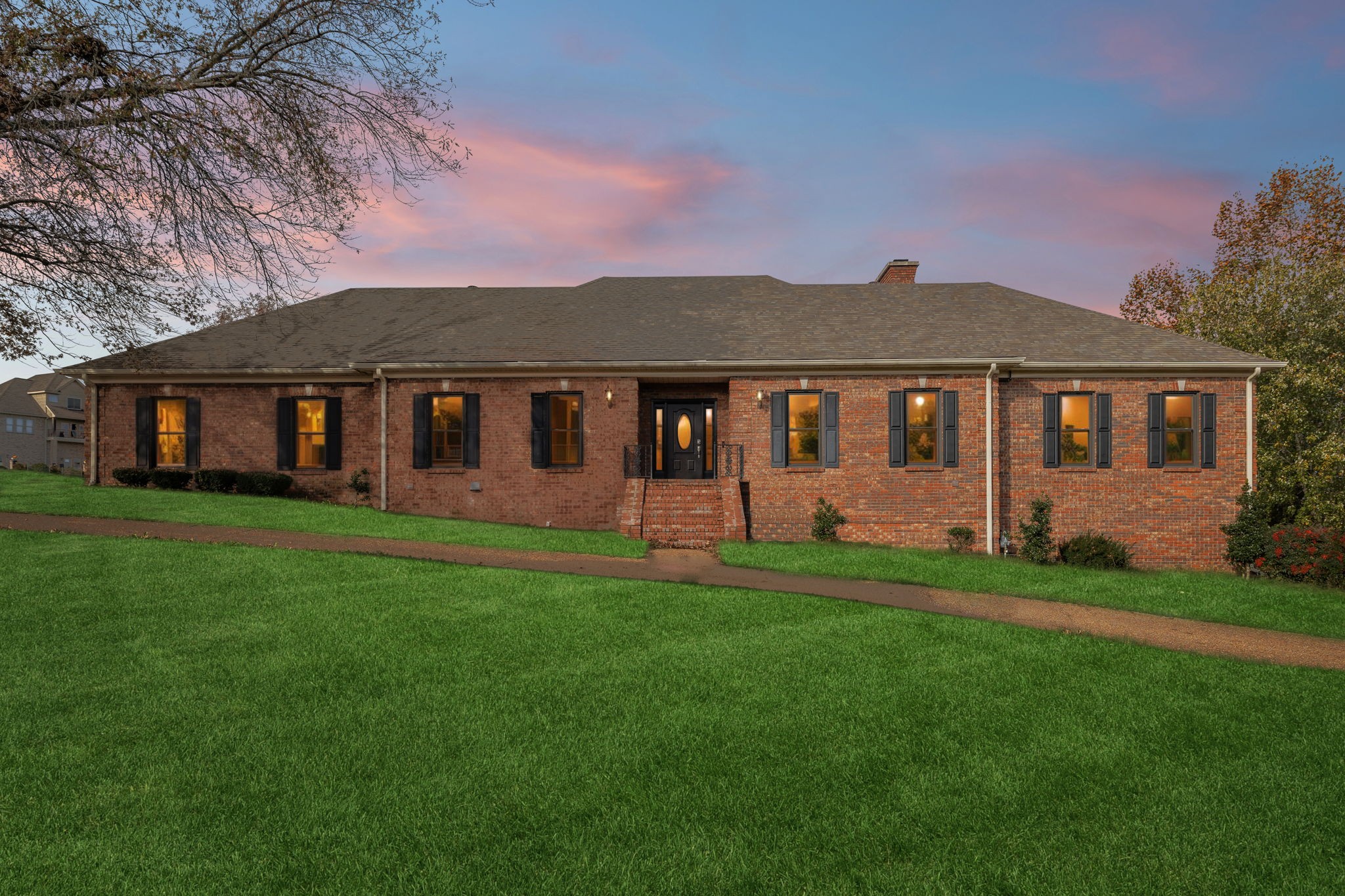 a front view of a house with a garden