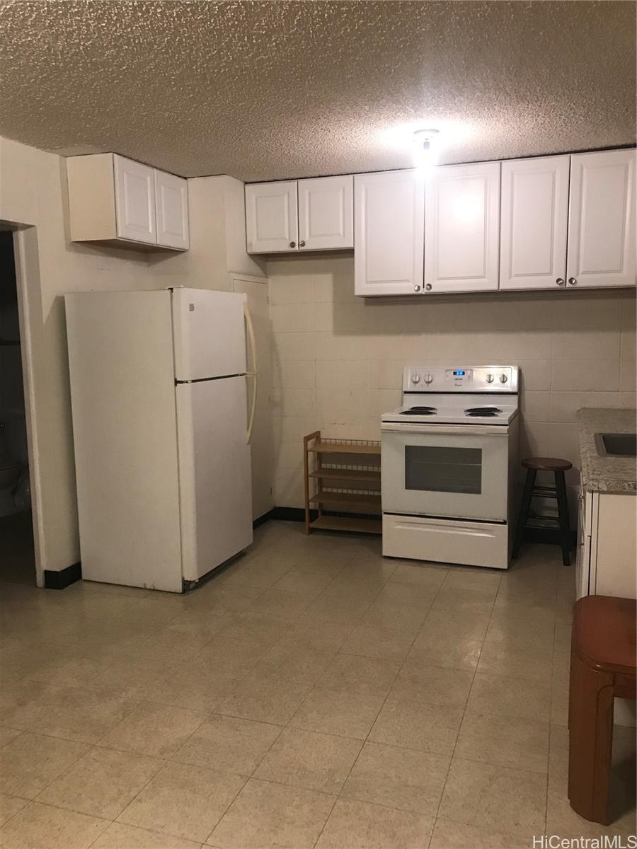 a view of a kitchen with cabinets and stainless steel appliances