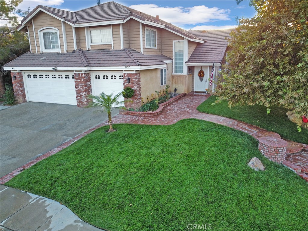 a front view of a house with a garden and plants