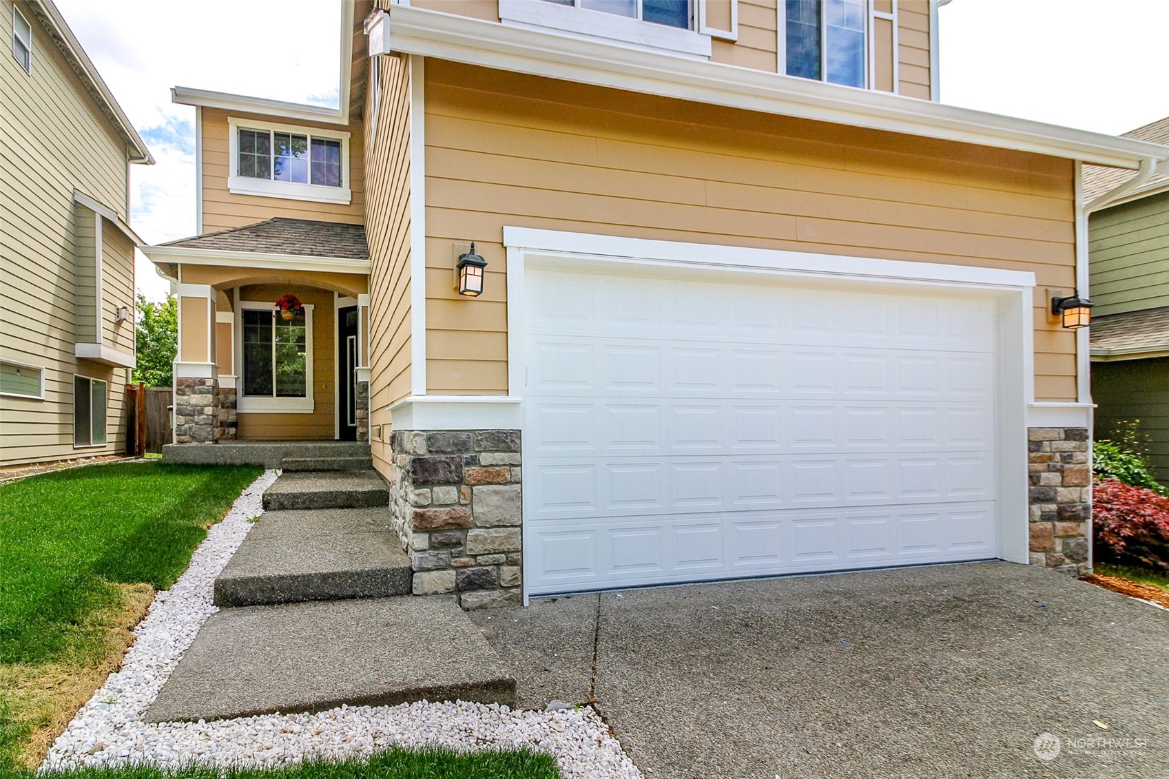 a front view of a house with a yard and garage