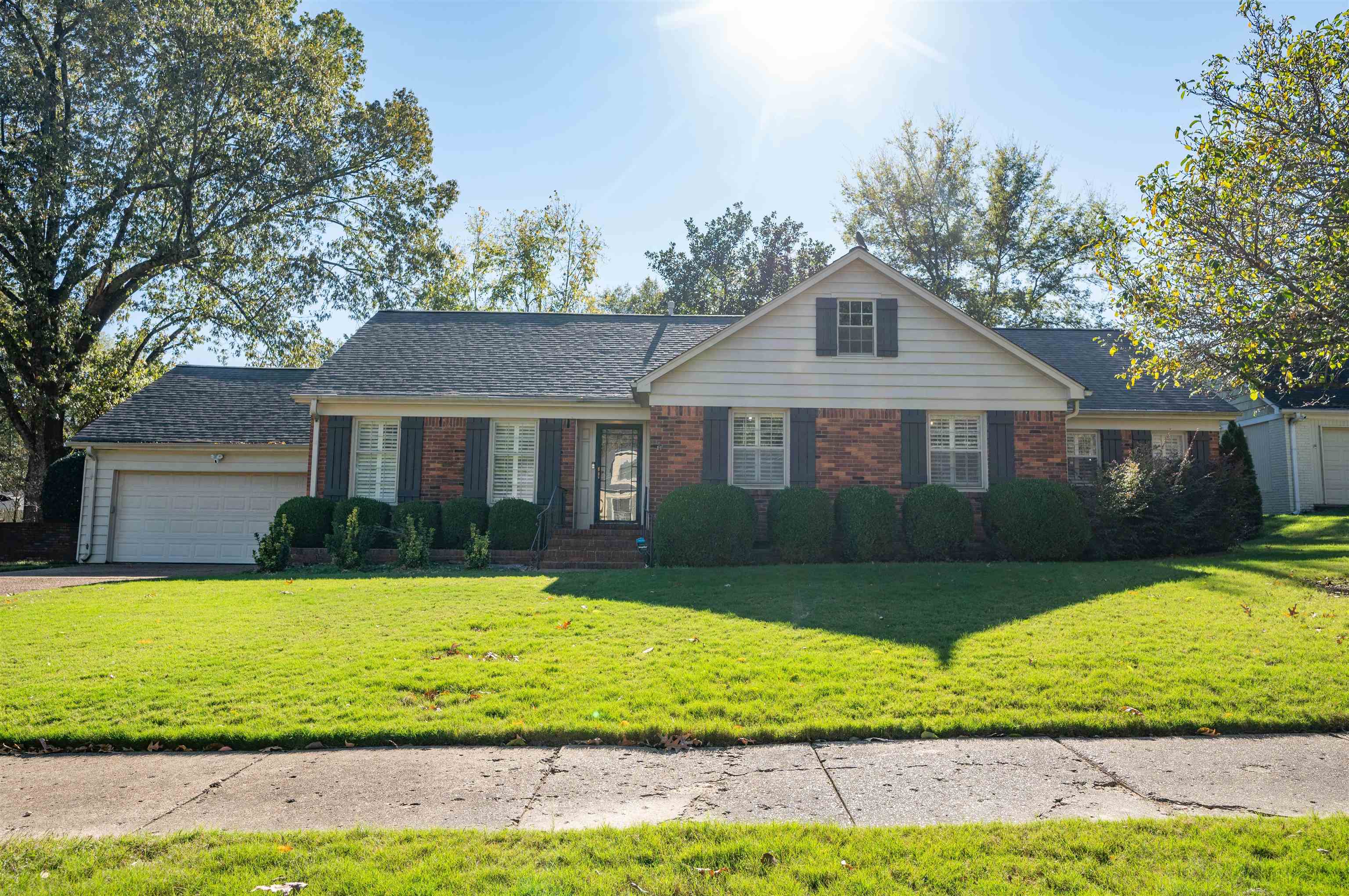 Ranch-style house featuring a garage and a front yard