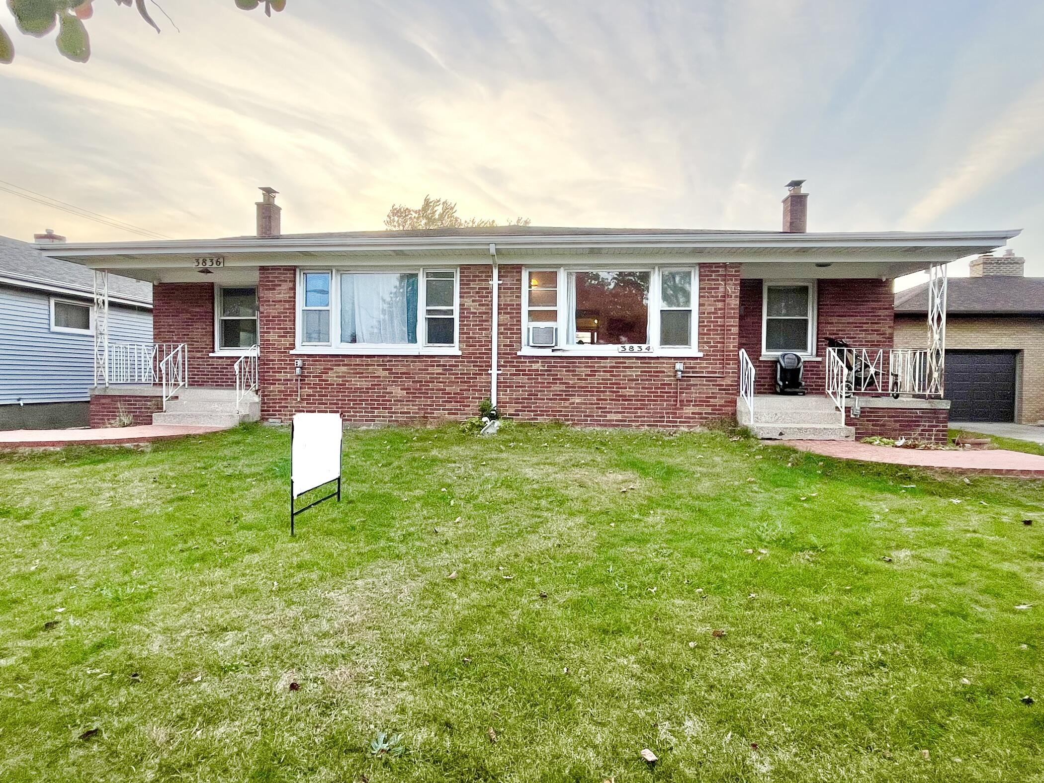 a front view of house with outdoor seating and yard