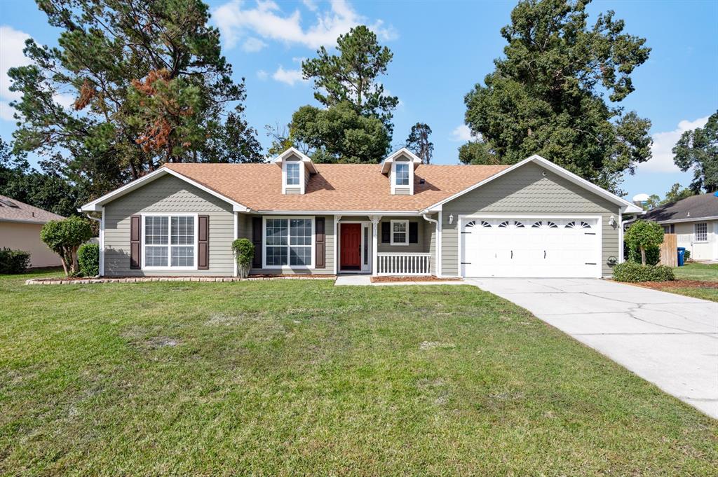 a view of a house with a yard and garage