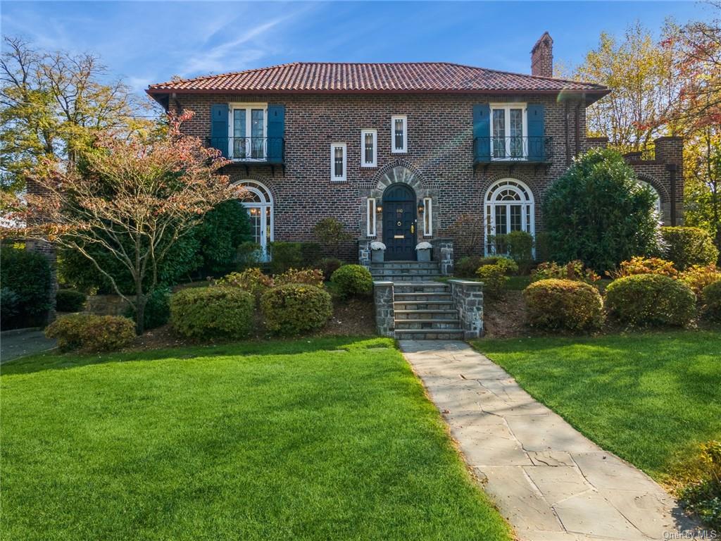 a front view of a house with a garden